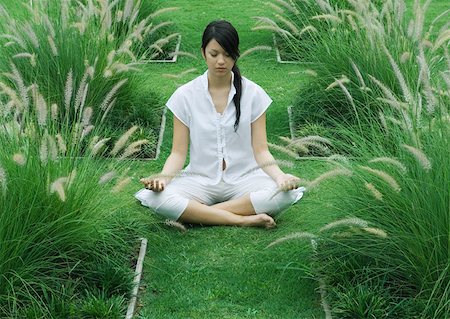 simsearch:633-01572611,k - Woman sitting on grass in lotus position Stock Photo - Premium Royalty-Free, Code: 633-01572557