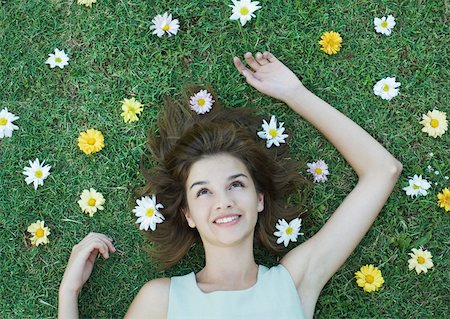 simsearch:633-01572611,k - Woman lying on grass with flowers scattered around head Stock Photo - Premium Royalty-Free, Code: 633-01572652