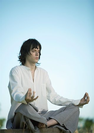 Young male meditator, eyes closed Stock Photo - Premium Royalty-Free, Code: 633-01572791