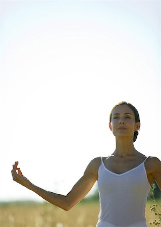 simsearch:632-03651843,k - Woman doing yoga pose in field Stock Photo - Premium Royalty-Free, Code: 633-01572805