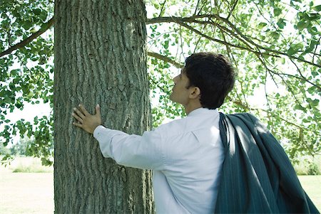 simsearch:633-01572737,k - Businessman touching tree trunk Foto de stock - Royalty Free Premium, Número: 633-01573620