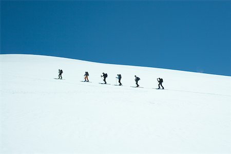 Skiers going up snowy slope, single file Stock Photo - Premium Royalty-Free, Code: 633-01573728