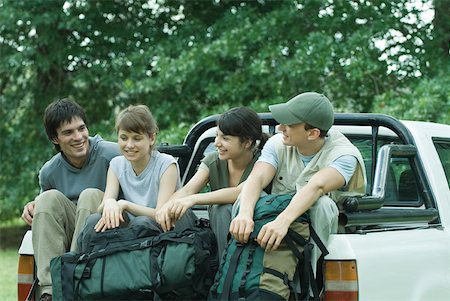 Group of hikers sitting in back of pick-up truck Stock Photo - Premium Royalty-Free, Code: 633-01573784