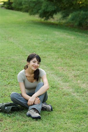 Junge Frau sitzend auf Gras, lächelnd in die Kamera Stockbilder - Premium RF Lizenzfrei, Bildnummer: 633-01714071