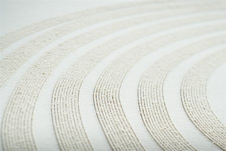 simsearch:670-06450558,k - Curve pattern traced in sand, close-up Stock Photo - Premium Royalty-Free, Code: 633-01714298