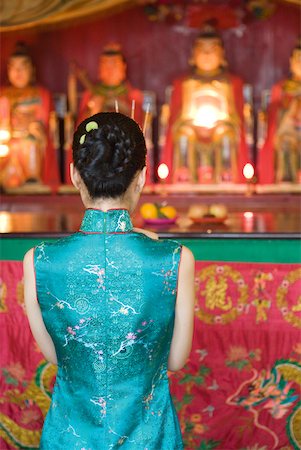 praying figure of female - Young woman wearing traditional Chinese clothing, in front of shrine, rear view Stock Photo - Premium Royalty-Free, Code: 633-01714670