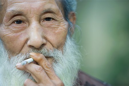simsearch:633-01714698,k - Elderly man smoking cigarette Stock Photo - Premium Royalty-Free, Code: 633-01714719