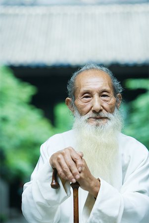 portrait chinese old man - Elderly man wearing traditional Chinese clothing, holding cane Stock Photo - Premium Royalty-Free, Code: 633-01714734