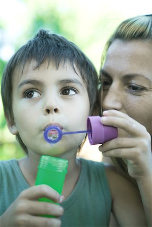 Boy and mother blowing bubbles, close-up Stock Photo - Premium Royalty-Free, Code: 633-01714813