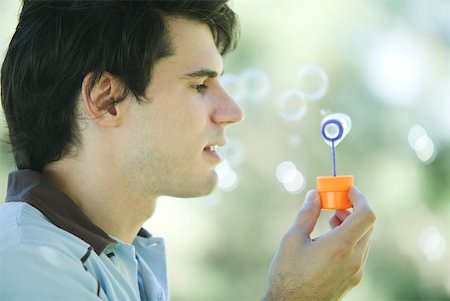 Man blowing bubbles Stock Photo - Premium Royalty-Free, Code: 633-01714917