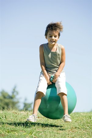 space hopper not illustration not monochrome - Little boy outdoors, jumping on ball, full length Stock Photo - Premium Royalty-Free, Code: 633-01714960