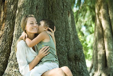 simsearch:632-02416107,k - Mother and son, woman holding flower, boy kissing her cheek Stock Photo - Premium Royalty-Free, Code: 633-01714973