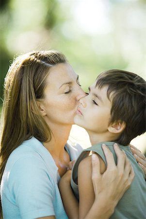 sulk boy - Mother and son, woman kissing boy on cheek Stock Photo - Premium Royalty-Free, Code: 633-01715011