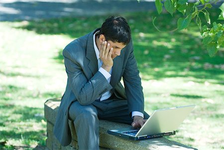 simsearch:633-01713826,k - Businessman sitting on low wall in park, using laZSop Stock Photo - Premium Royalty-Free, Code: 633-01715287