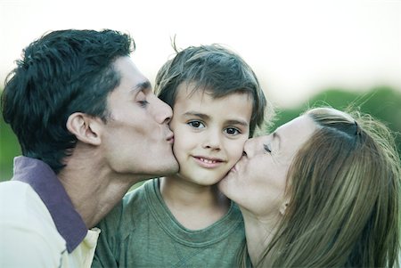 simsearch:695-03375963,k - Boy being kissed on both cheeks by parents, smiling at camera Stock Photo - Premium Royalty-Free, Code: 633-01715359