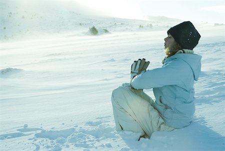 Teen girl sitting on snow in prayer position Stock Photo - Premium Royalty-Free, Code: 633-01713718