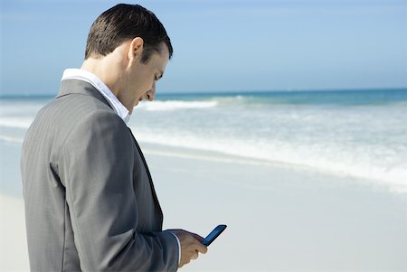 simsearch:633-01574593,k - Businessman on beach, using cell phone Stock Photo - Premium Royalty-Free, Code: 633-01713795