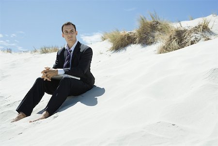 simsearch:633-01713826,k - Businessman sitting on sand dune, closed laZSop on lap Stock Photo - Premium Royalty-Free, Code: 633-01713813