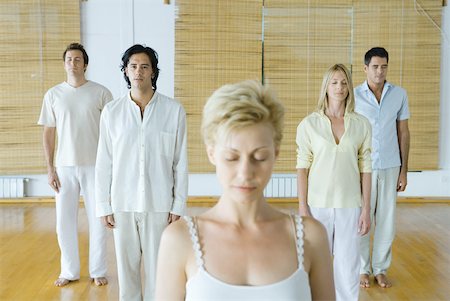 Group of adults standing, meditating, all with eyes closed exceZS one Stock Photo - Premium Royalty-Free, Code: 633-01713922