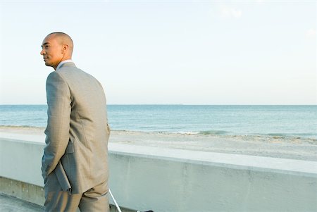 simsearch:632-01828543,k - Businessman walking by the sea, looking away Foto de stock - Royalty Free Premium, Número: 633-01837086