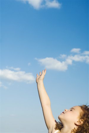 simsearch:633-02417937,k - Little girl reaching one hand toward sky, head back, eyes closed, cropped view Stock Photo - Premium Royalty-Free, Code: 633-01837280