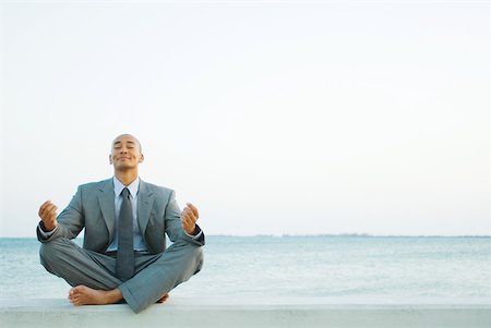 dimpled - Businessman sitting in lotus position at the beach, eyes closed Stock Photo - Premium Royalty-Free, Code: 633-01992762