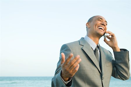 simsearch:633-01574593,k - Businessman at the beach using cell phone, smiling, eyes closed Stock Photo - Premium Royalty-Free, Code: 633-01992793