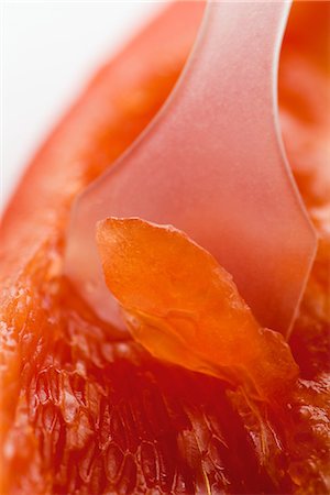 Spatula scooping grapefruit flesh, extreme close-up Stock Photo - Premium Royalty-Free, Code: 633-01992902