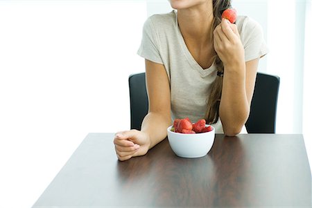 simsearch:693-06021794,k - Female eating strawberries, cropped Stock Photo - Premium Royalty-Free, Code: 633-02044199