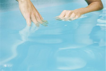 Man dipping hands in water, close-up, cropped Stock Photo - Premium Royalty-Free, Code: 633-02044333