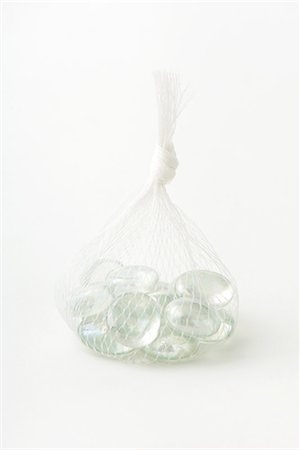 simsearch:633-02345827,k - Glass pebbles in mesh bag, close-up Stock Photo - Premium Royalty-Free, Code: 633-02044496