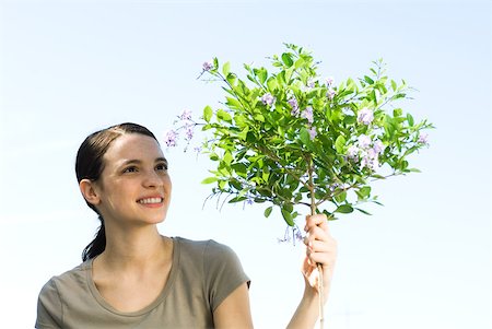 simsearch:633-02066083,k - Young woman with flowering topiary tree Stock Photo - Premium Royalty-Free, Code: 633-02065774
