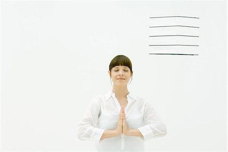 Woman in prayer position, smiling, eyes closed Stock Photo - Premium Royalty-Free, Code: 633-02065799