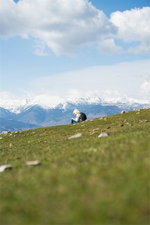 Hiker sitting in mountain landscape Stock Photo - Premium Royalty-Free, Code: 633-02065973