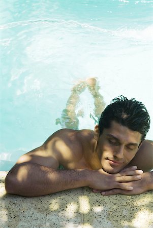 simsearch:632-07161660,k - Man holding on to side of swimming pool, head resting on arms, eyes closed Stock Photo - Premium Royalty-Free, Code: 633-02065987