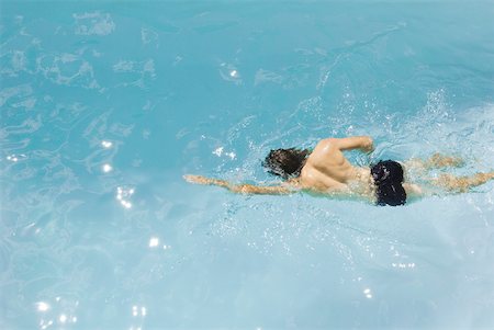 simsearch:614-03506503,k - Man swimming in pool, high angle view Stock Photo - Premium Royalty-Free, Code: 633-02065994