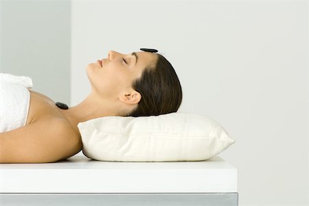 Woman receiving lastone therapy, eyes closed Stock Photo - Premium Royalty-Free, Code: 633-02066090