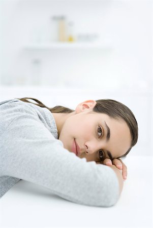 pic of person head down arms crossed - Female resting head on arms, looking at camera Stock Photo - Premium Royalty-Free, Code: 633-02128663