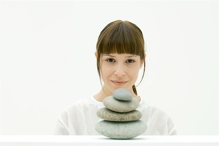 Woman with stack of stones, portrait Stock Photo - Premium Royalty-Free, Code: 633-02128692