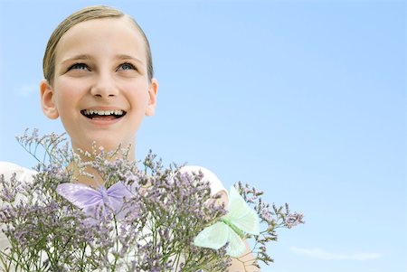 simsearch:633-01273290,k - Girl with plant and fake butterflies, looking up, smiling Stock Photo - Premium Royalty-Free, Code: 633-02128714