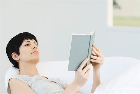 simsearch:633-08151062,k - Woman reclining in chair, reading book Stock Photo - Premium Royalty-Free, Code: 633-02128774