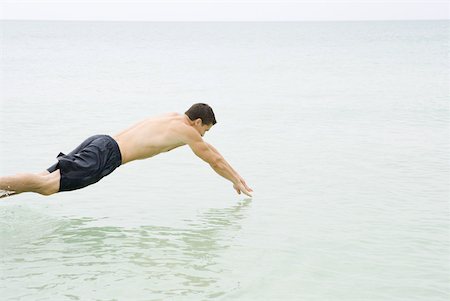 simsearch:633-01274929,k - Man diving into the ocean, side view Stock Photo - Premium Royalty-Free, Code: 633-02231685