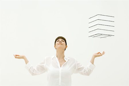 schweben - Woman meditating, cube hovering in midair over her left hand, head back, eyes closed Foto de stock - Sin royalties Premium, Código: 633-02231766