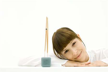 Woman sitting near incense, eyes closed Stock Photo - Premium Royalty-Free, Code: 633-02345730