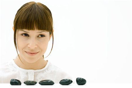 simsearch:633-02345856,k - Woman looking away over five stones in a line Stock Photo - Premium Royalty-Free, Code: 633-02345731