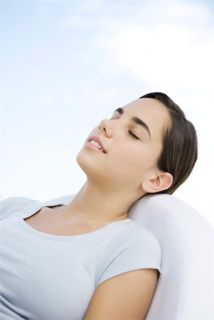 simsearch:695-03378071,k - Teenage girl reclining in chair, eyes closed Stock Photo - Premium Royalty-Free, Code: 633-02345785