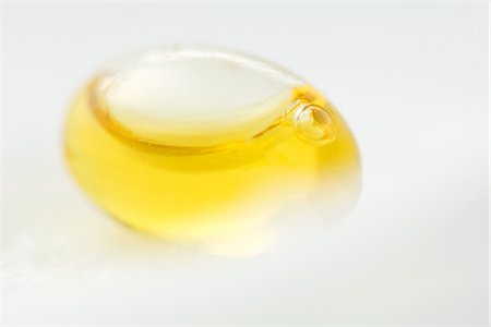 dietary supplements container - Yellow liquid inside of egg-shaped container, close-up Stock Photo - Premium Royalty-Free, Code: 633-02345837