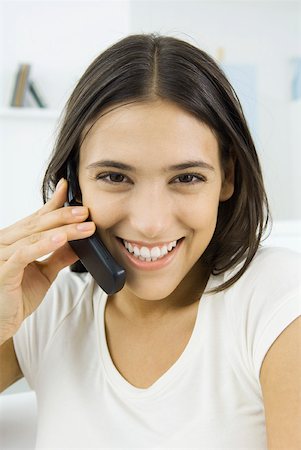 simsearch:632-02745019,k - Woman talking on the phone, smiling at camera Stock Photo - Premium Royalty-Free, Code: 633-02345869