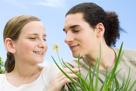 simsearch:633-02645343,k - Young man and preteen girl smelling flowering aloe plant, eyes closed Stock Photo - Premium Royalty-Free, Code: 633-02345881