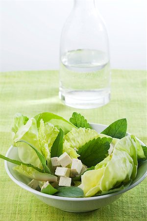 salad bowl top view - Salad of mixed greens and tofu cubes, carafe of water in background Stock Photo - Premium Royalty-Free, Code: 633-02417347